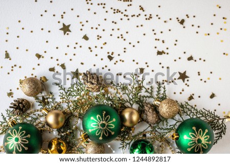green and golden frame for Christmas. fir, stars, cones and tree balls on white table