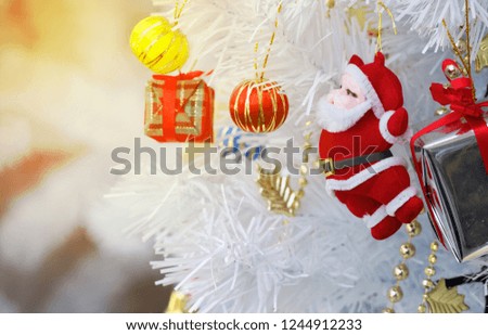 Cristmas , Santa claus with giftbox and golden bell in front of Cristmas tree
