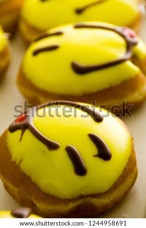 Happy faces with smiley as funny filled doughnuts to eat