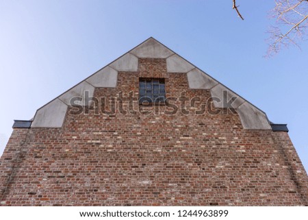 Europe, Belgium, Bruges, Pyramid of Khafre, a large brick building with a clock tower with Pyramid of Khafre in the background