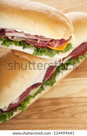 Close up image of ham sandwiches on wooden table