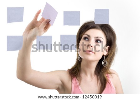 A girl sticking notes on the glass wall