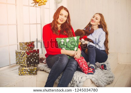 two elegant and pretty ladies at home celebrate christmas