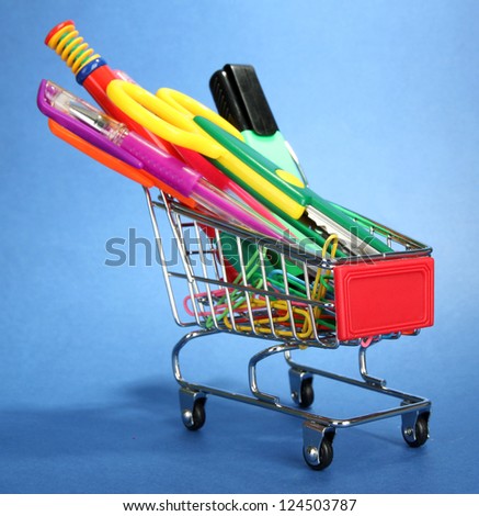 trolley with school equipment on blue background
