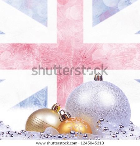 Christmas background with England flag on frosted windowpane, big silver ball and golden balls