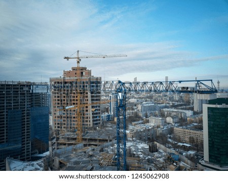 Tower cranes in the city center. Construction of high-rise buildings. Photo on drone from the air.