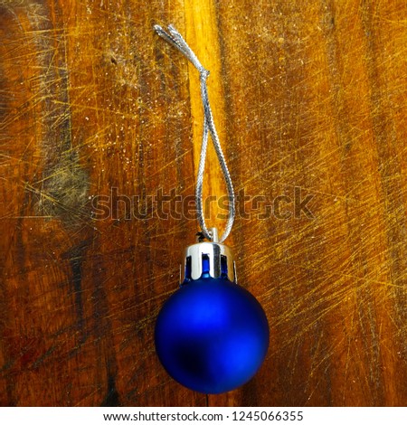 Christmas ball on a brown wooden background. Christmas composition, winter season. For your design.