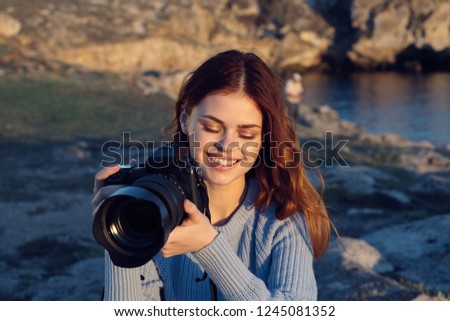 Photographer with a camera in hand in nature                          