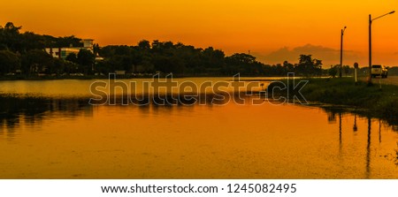 Lake after sunset in the countryside of Thailand. In the peaceful nature of the countryside.Silhouette picture