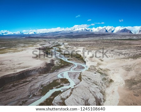 Drone photo of the Himalaya mountain range and rivers on a sunny day