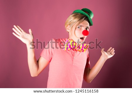 Young funny clown. Red background.