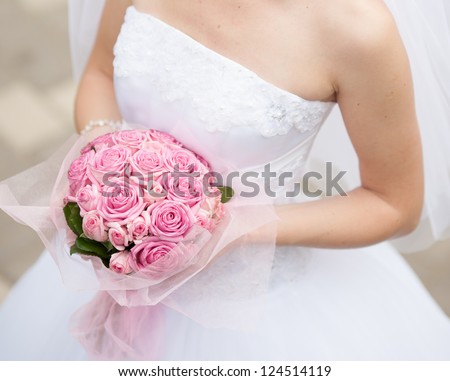 Beautiful wedding bouquet in hands of the bride Royalty-Free Stock Photo #124514119