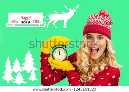 Very beautiful girl with a clock, looks at the time of the cord will come the new year. Deer with sleds are carrying the new year