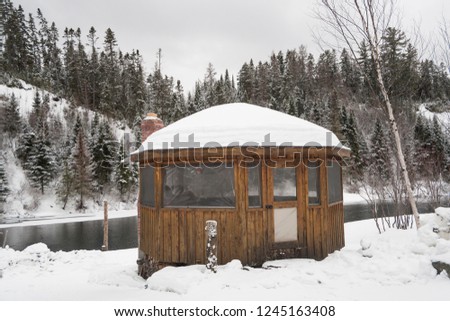 Winter landscape with gazebo and river