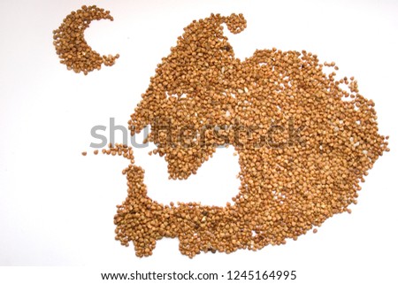 Grains of buckwheat on a white background in the form of a silhouette of a man who wants to sleep