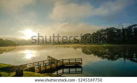 LANDSCAPE OF DA LAT CITY, XUAN HUONG LAKE IS FAMOUS LAKE IN CETRAL OF DA LAT CITY, THE LAKE UNDER THE SUN AND FOG 