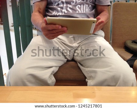 Male asian with digital tablet.