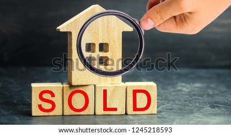 wooden house with the inscription "sold". sale of property, home, real estate. affordable housing.