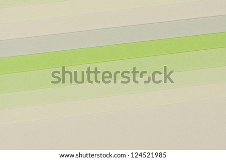 Color paper samples in various green tones as background.