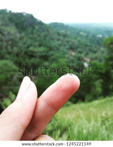 the fingers form a symbol of love from the top of the hill