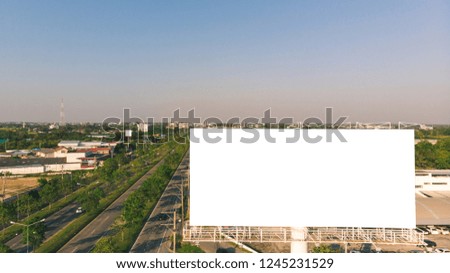 Blank billboard at blue sky background and road