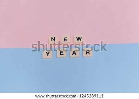 Wording word "NEW YEAR" on Pink and Blue paper.