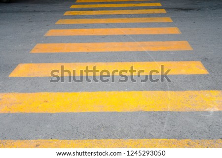 Yellow Crosswalk - The yellow coloring is designed to alert drivers in supermarket parking area