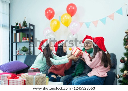 Picture showing group of friends celebrating Christmas at home. surprised friend happy in office
