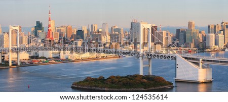 Panorama of Tokyo as seen from Odaiba at sunrise, with the Rainbow Bridge and Tokyo Tower