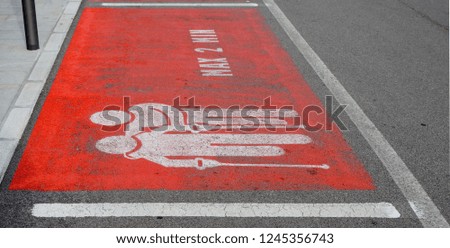 Reserved parking for elderly, disable and sick people for a maximum of two minutes. Courtesy road sign on the asphalt