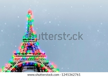 Eiffel Tower (Paris, France) with Christmas lights. Copy space background for holiday card/wallpaper.