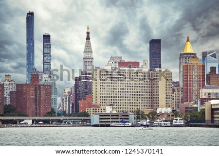 Manhattan skyline on a cloudy day, color toning applied, New York City, USA.