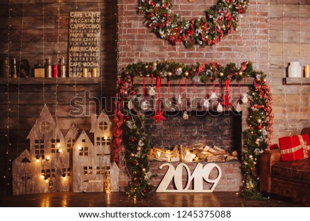 christmas loft room interior with wood letters new year 2019 decorated by lights gifts toys candles holiday concept