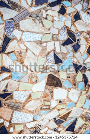 Closeup of neutral coloured beige and turquoise abstract mosaic ceramic tiles patterned background