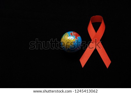 World AIDS Day. World Aids Day poster.Red ribbon on world globe