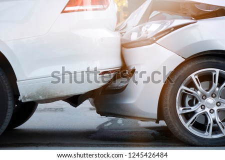 Auto accident involving two cars on a city street Royalty-Free Stock Photo #1245426484