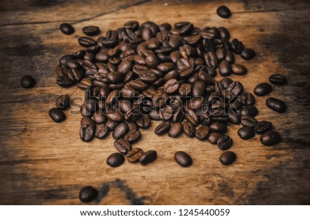 Coffee beans on a wooden surface. Copy-space. selective focus