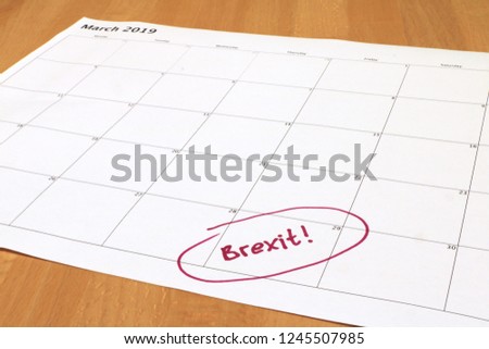 Brexit - calendar for March 2019 with March 29 2019 circled and Brexit! written in felt tip. Calendar is on a wooden background. Image is with perspective view. Date is planned exit day for UK from EU Royalty-Free Stock Photo #1245507985