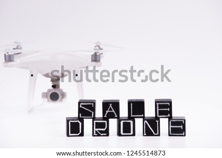 Flying drones on a white background with inscriptions "sale drone" 