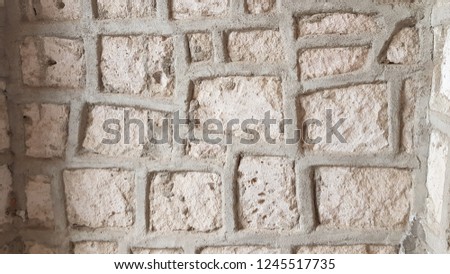 Antique wall with cement seams. Ancient brick wall in Derinkuyu underground city of Turkey. Textured background. Old stone bricks texture. Weathered aged surface. Rough limestone wall backdrop.