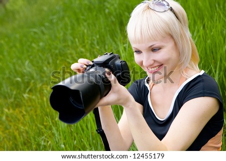 beautiful blond girl with photo camera