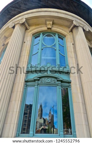 Building in downtown milwaukee showing a reflection of the city in the window