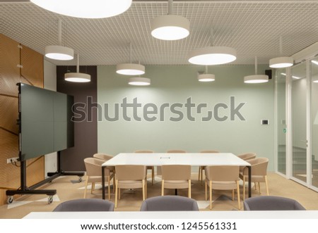 Modern office meeting room interior with blank presentation screen. Include clipping path around screen. 3d illustration