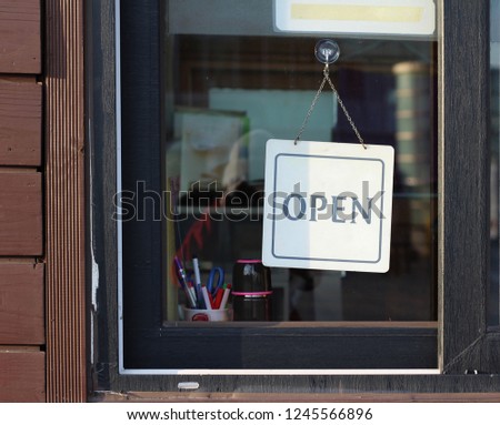 open sign hanging in a shop window