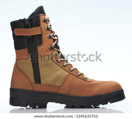 Brown tall military shoe side view isolated on white background