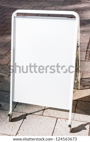 blank white board at a sidewalk