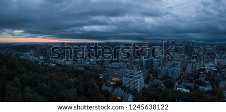 Aerial panoramic view of a beautiful modern downtown city during a striking cloudy sunrise. Taken in Montreal, Quebec, Canada.