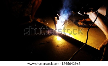 Arc welding work at night.Steel fabrication at night with welder.