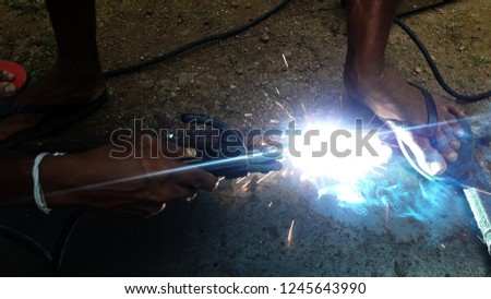 Arc welding work at night.Steel fabrication at night with welder.