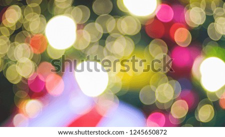 defocused of beautiful colorful bokeh light shining from a decorated of Christmas tree , Christmas theme concept background.